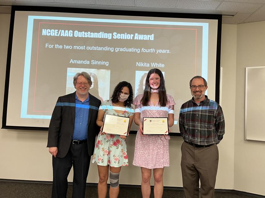 Nikita White (center left) and Amanda Sinning (center right) receive the Outstanding Senior Award