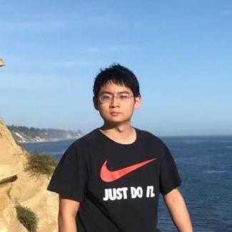 Dr. Gengchen Mai poses near the ocean 