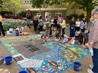 Students contribute to a temporary mosaic installation