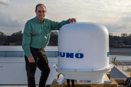 GTU Professor poses with the new weather radar